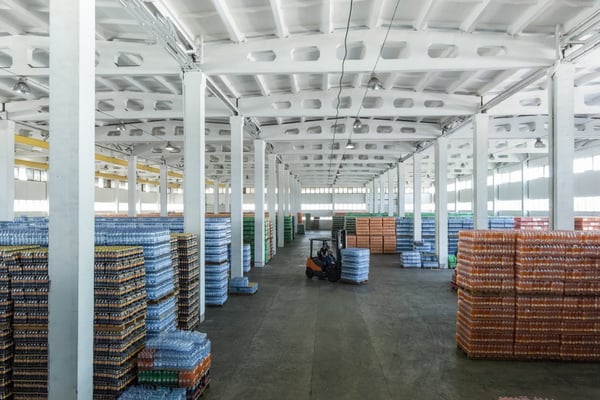 forklift moves pallets into place in warehouse